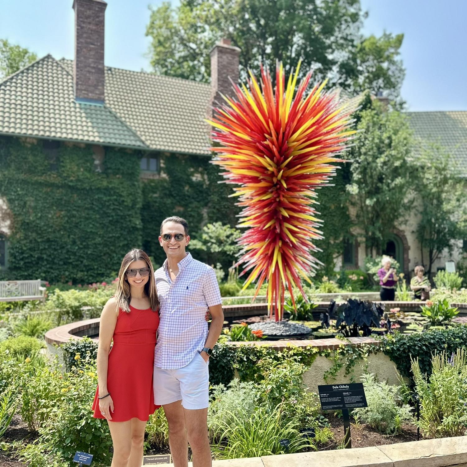 July 2024 - posing with a sculpture by our favorite blown glass artist Dale Chihuly at the Denver Botanic Gardens