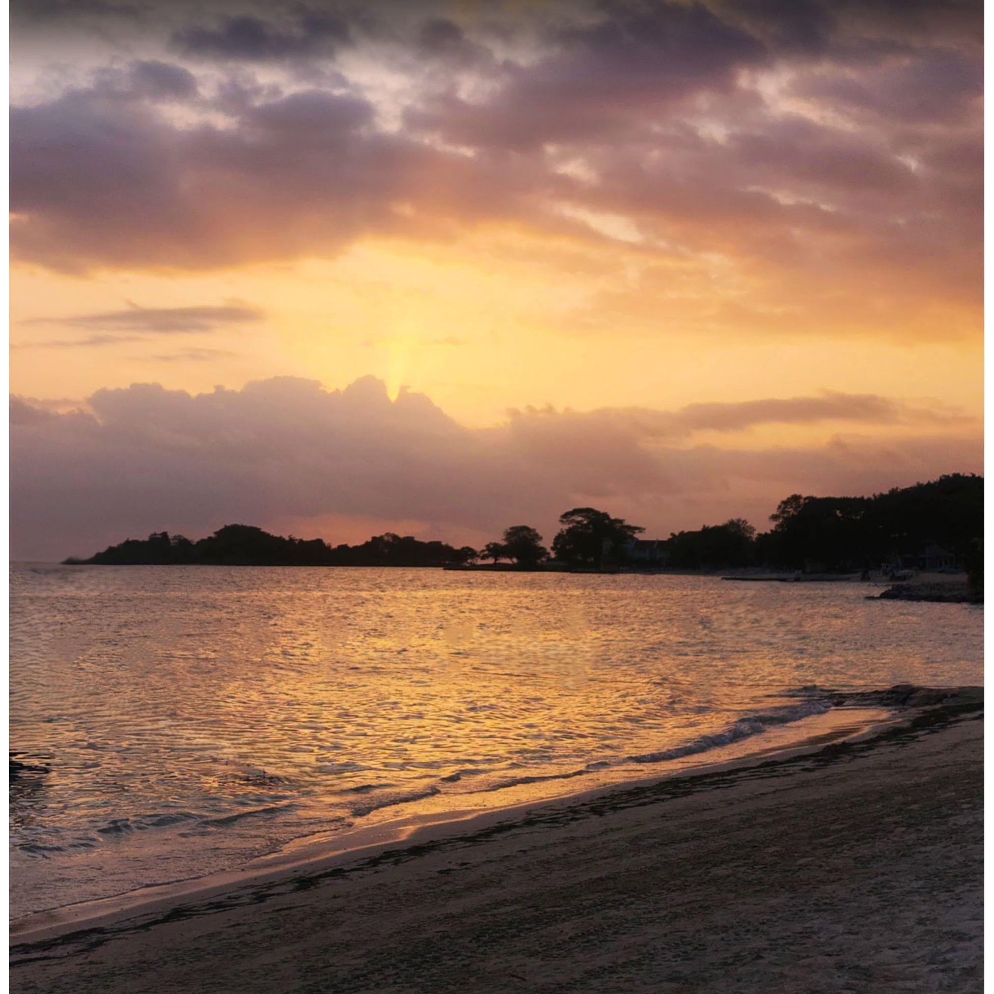 Hand in hand under a sky on fire, with the ocean whispering forever