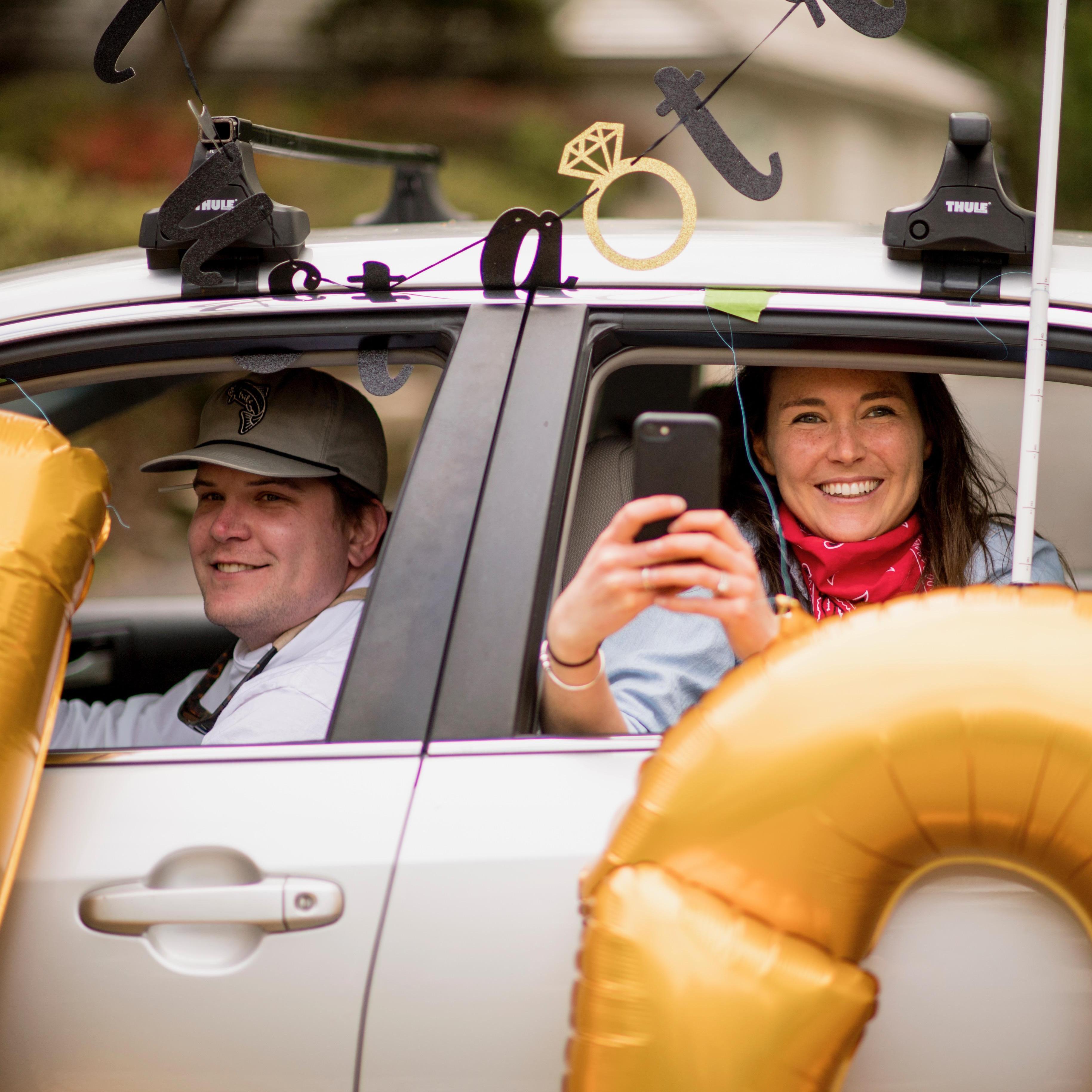 Liz + Greg in the car pararde! - Scott Zuehlke Photography