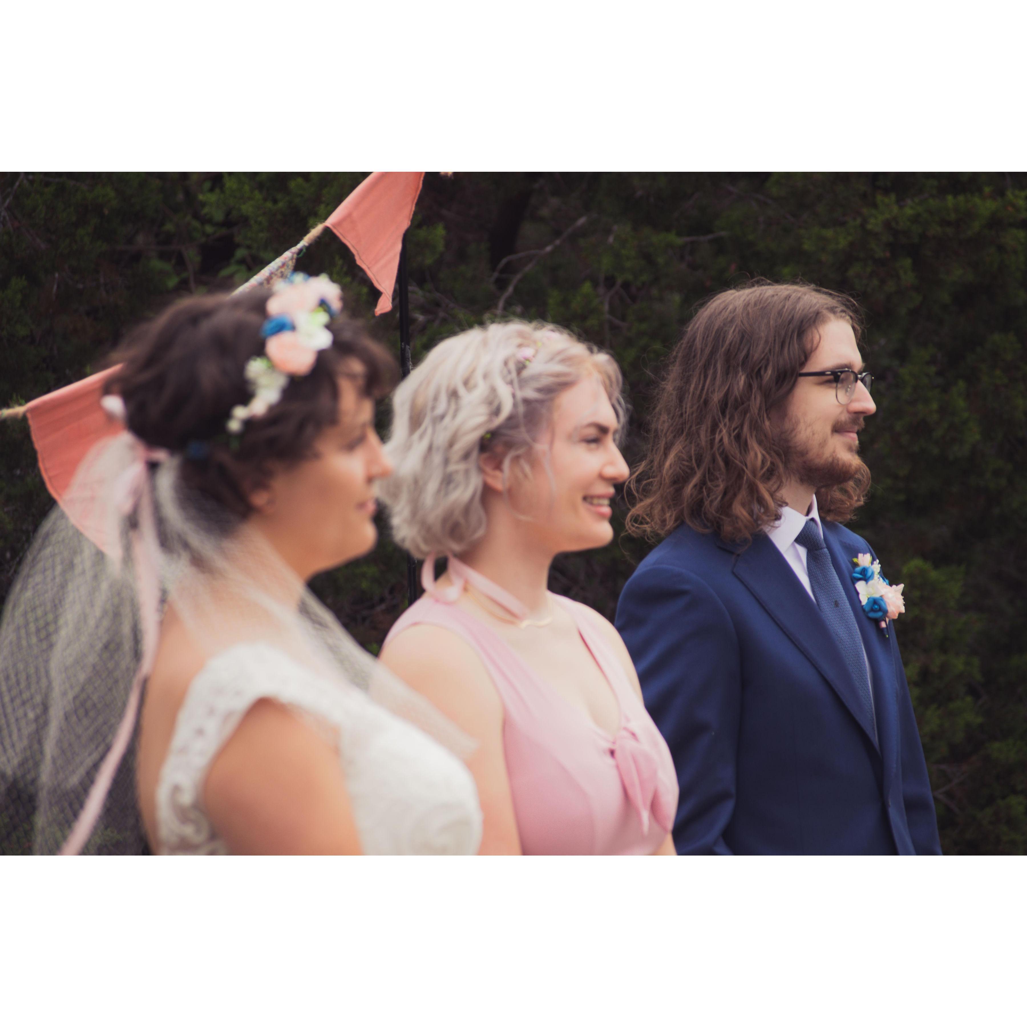 Bride and groom with the officiant during the ceremony.