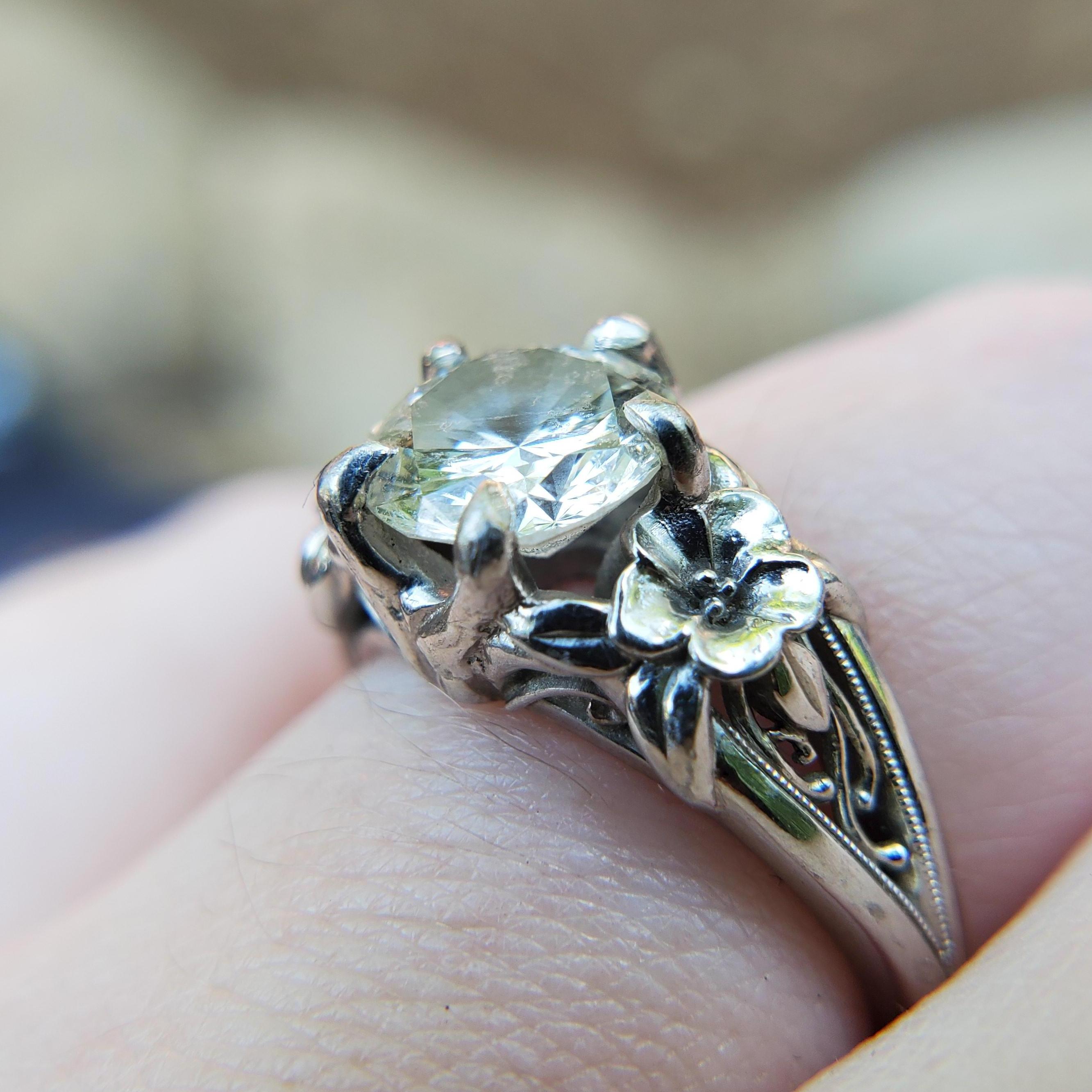 The ring, designed by Devan himself. The diamond of Mary K Dooley's engagement ring, a cherished family heirloom, accompanied by two columbine flowers.