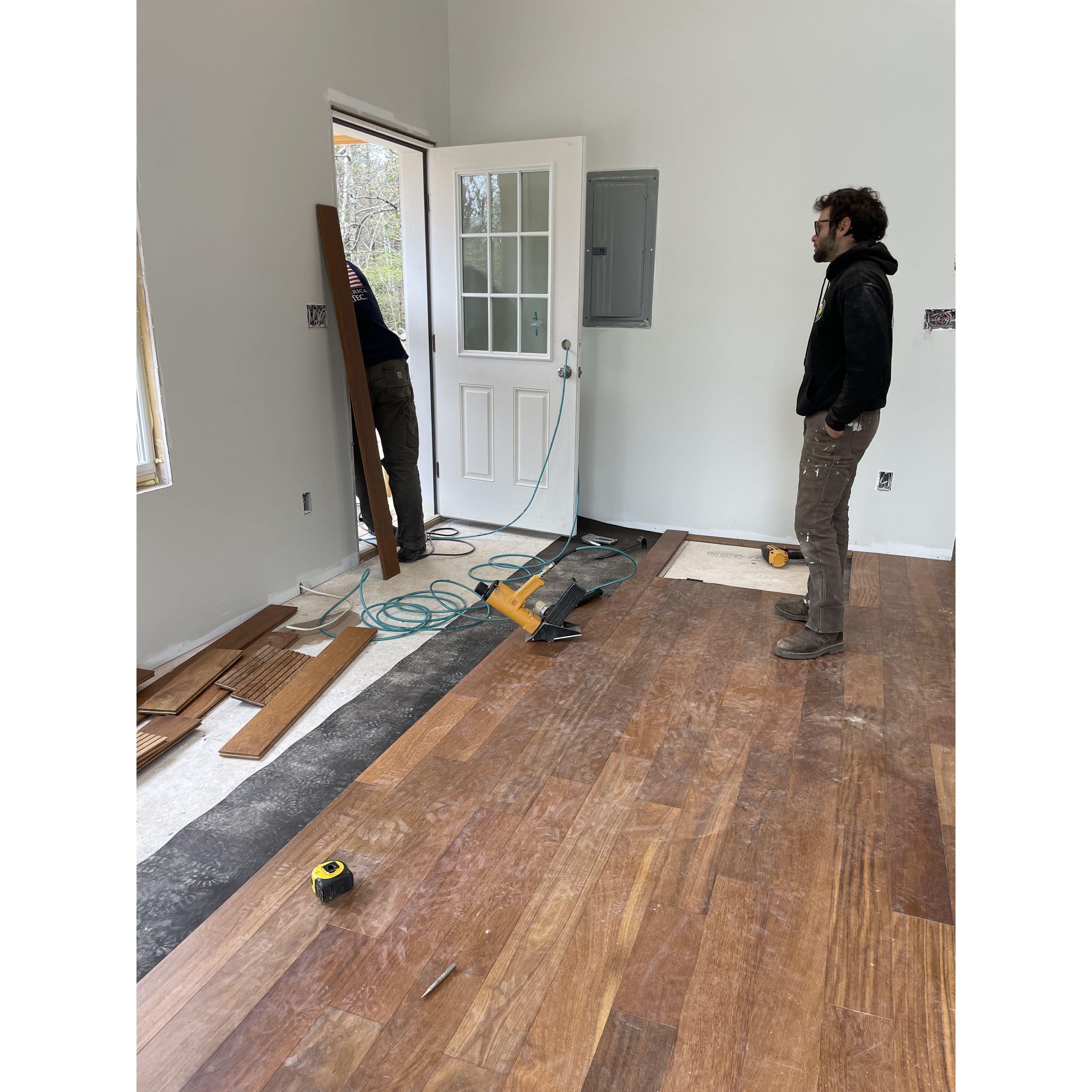 Sam and Matt laying the wood floors in our home