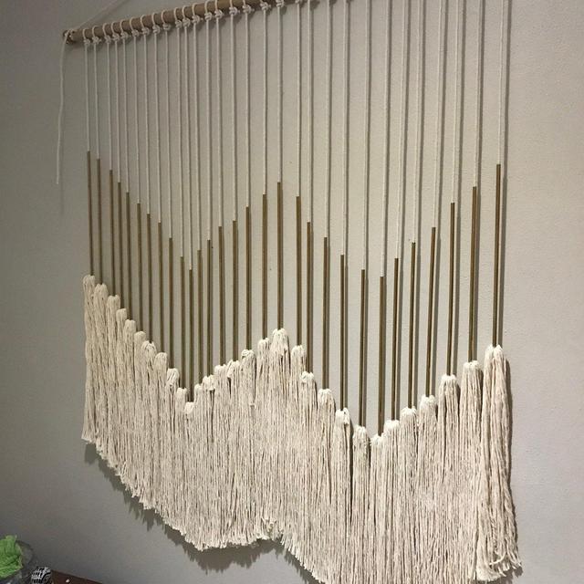 Macrame wall hanging with gold accents and tassels