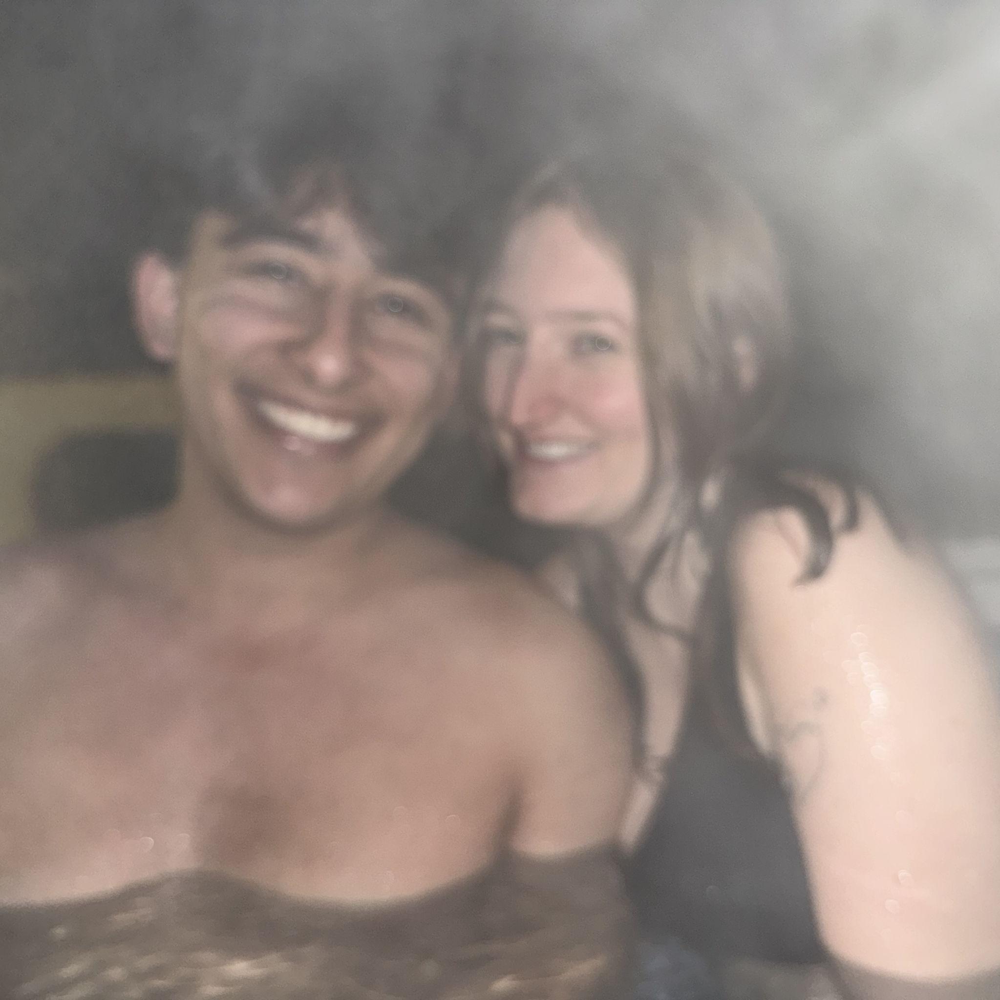 The bride & groom enjoying the mountains in a hot tub
