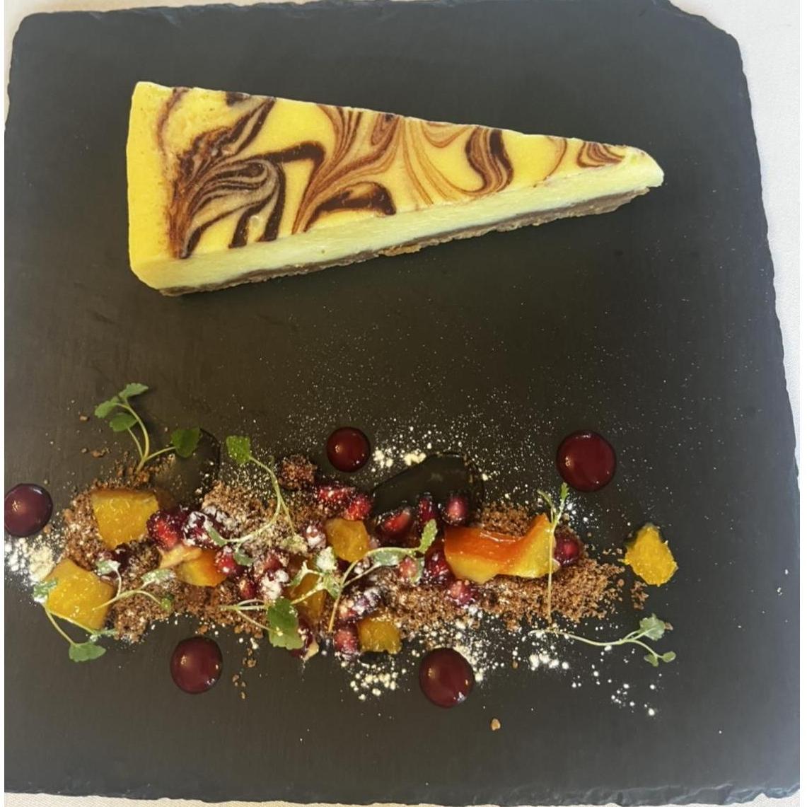 Dessert: Baked white chocolate cheesecake with chocolate crunch and orange salsa