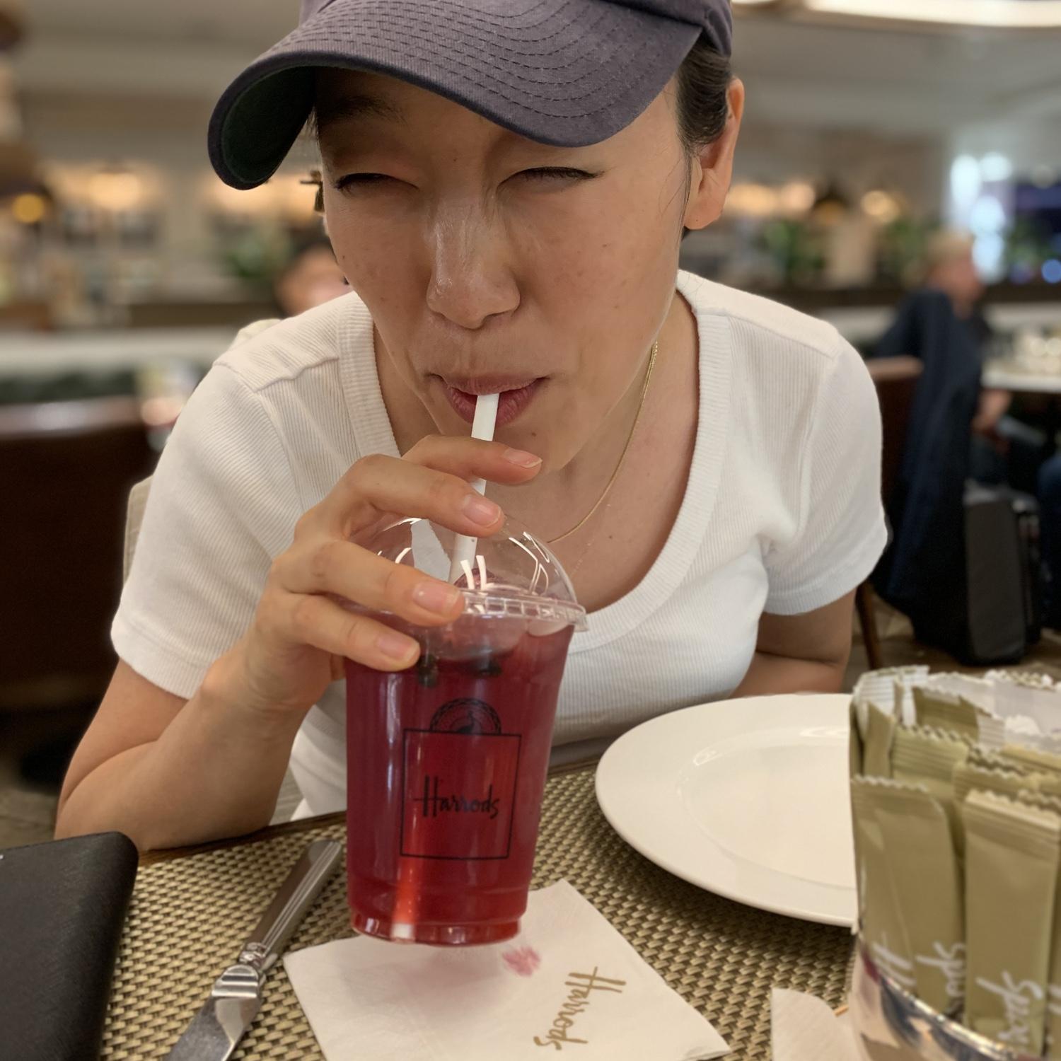 ...slurping her favorite hibiscus berry tea...