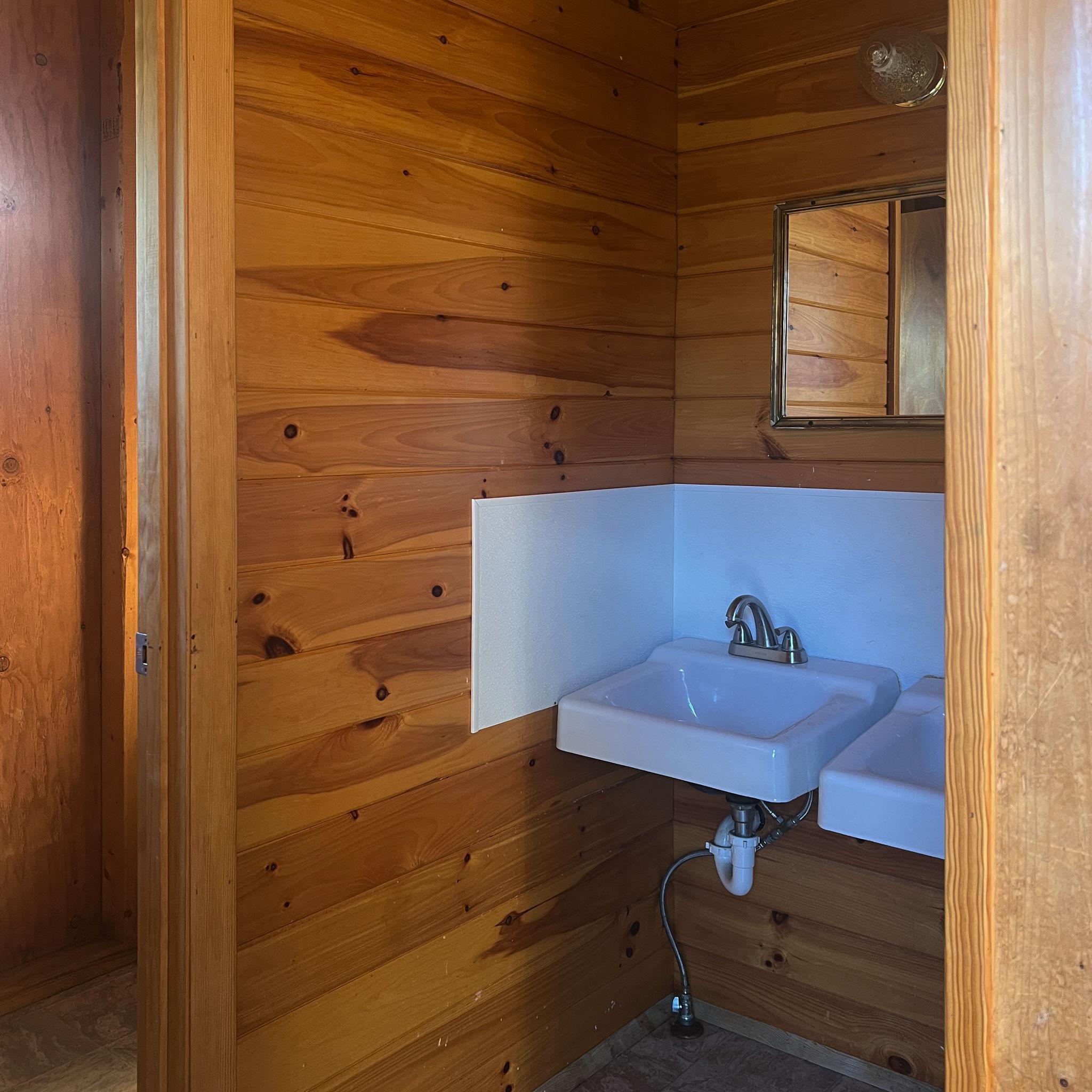 Camp Neringa cabin interior. Each cabin has a sink & toilet.
