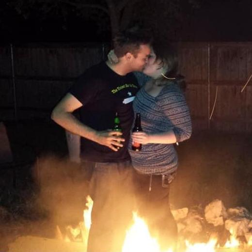 Very early in our relationship. Sharing a kiss over a fire pit.