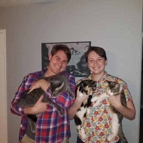 The night that we told our parents that we were engaged, posing with our cats