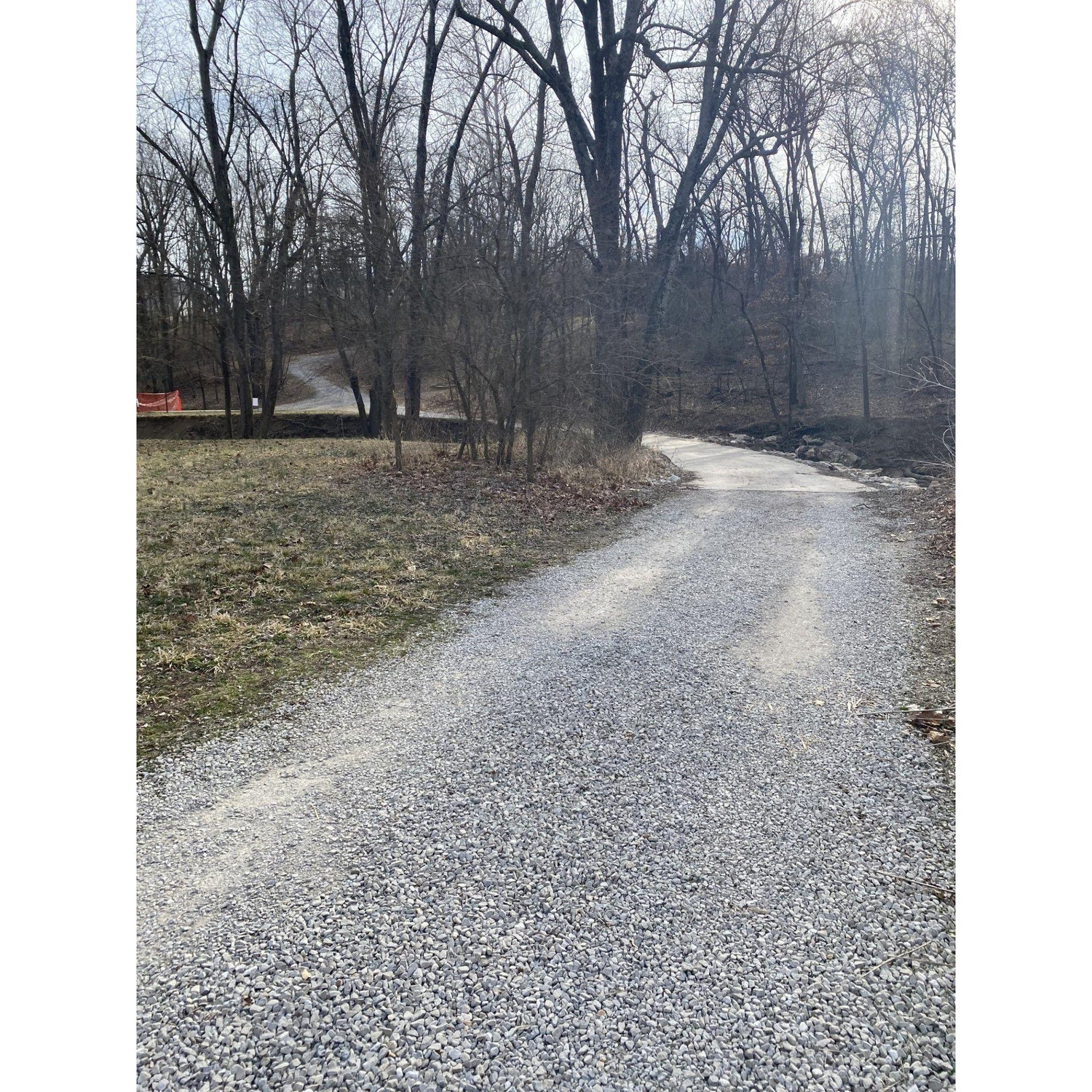 Walk the gravel road which will go over the bridge