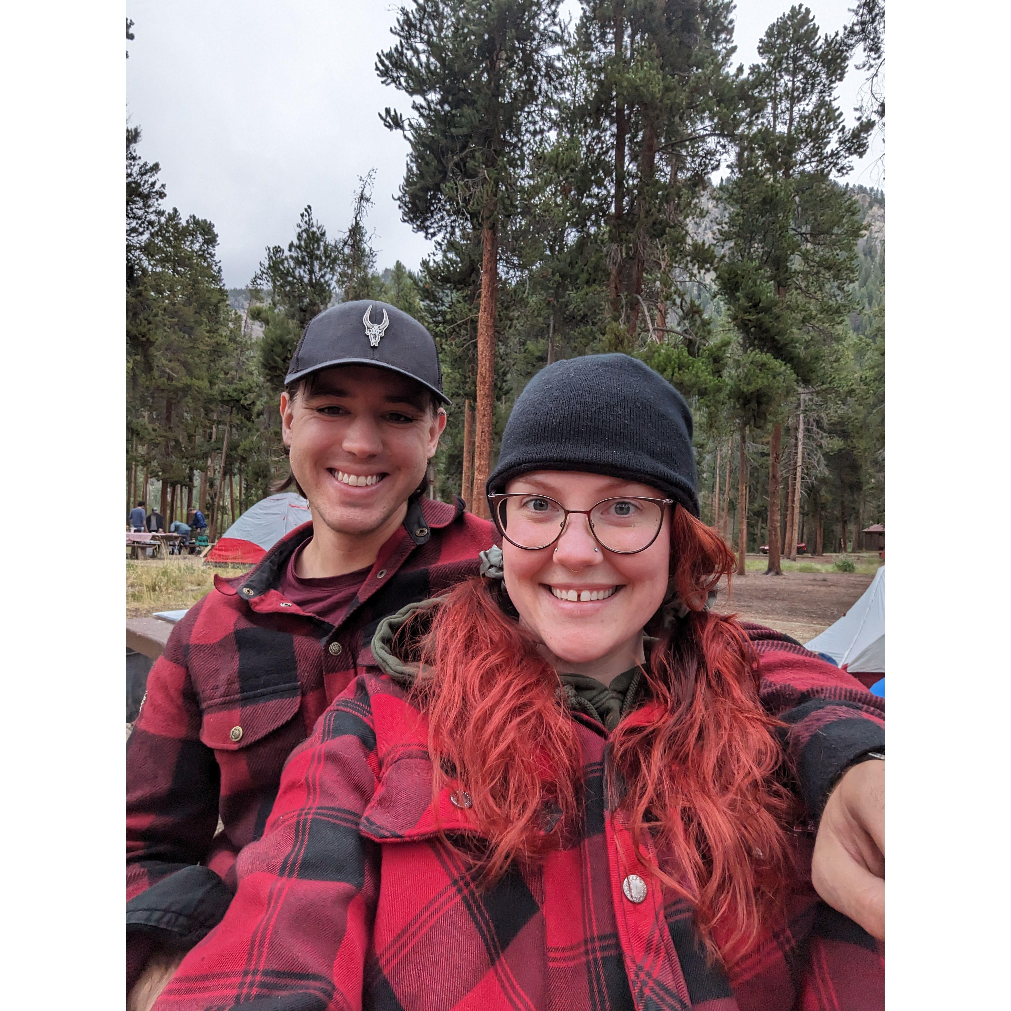 Couple of buffalo-plaid-clad happy campers