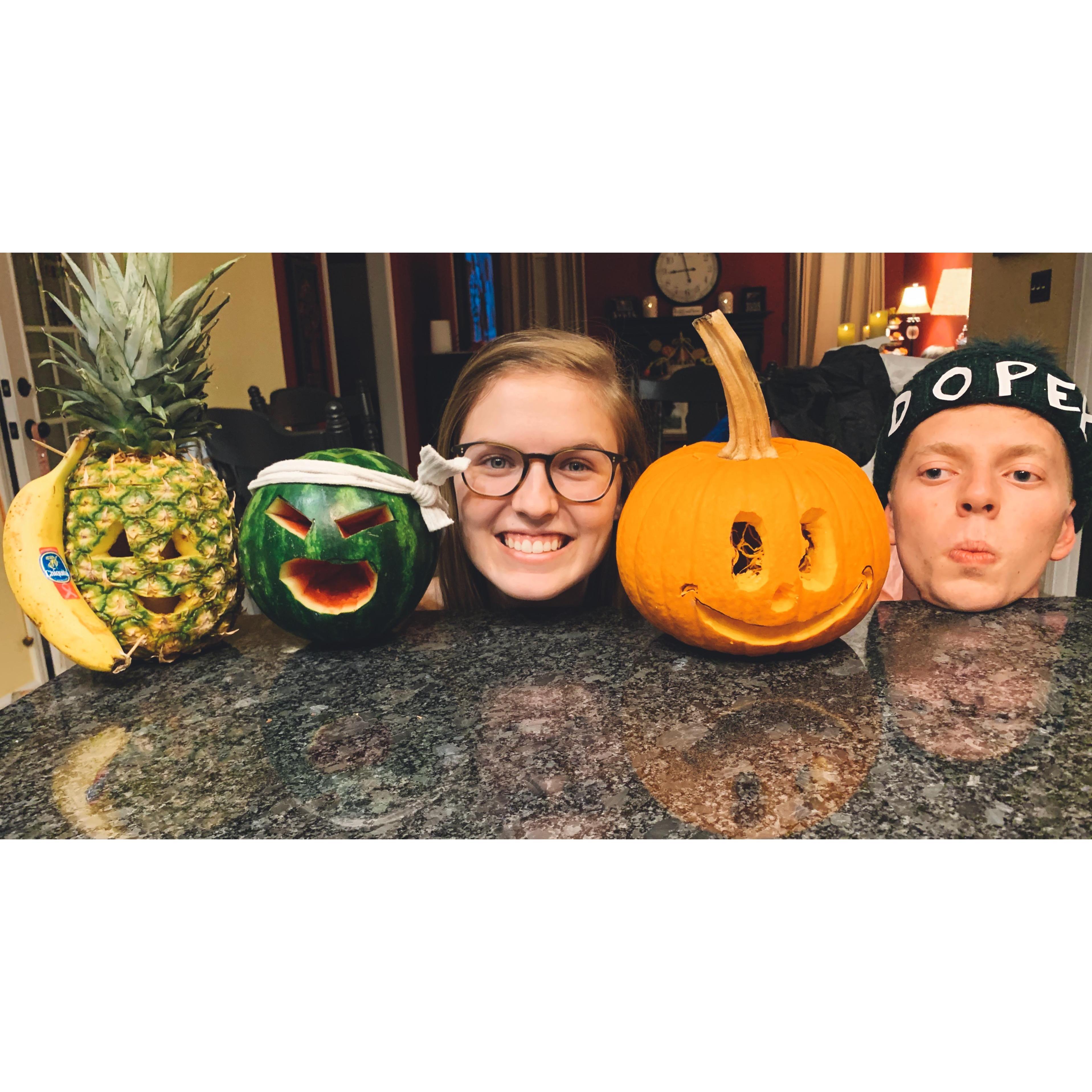Fun tradition we started. Every Halloween we carve a pumpkin, a pineapple, and a watermelon. This year we had "Banana Phone," "Fruit Ninja," and "Smiling Pumpkin." Guess who came up with each idea!