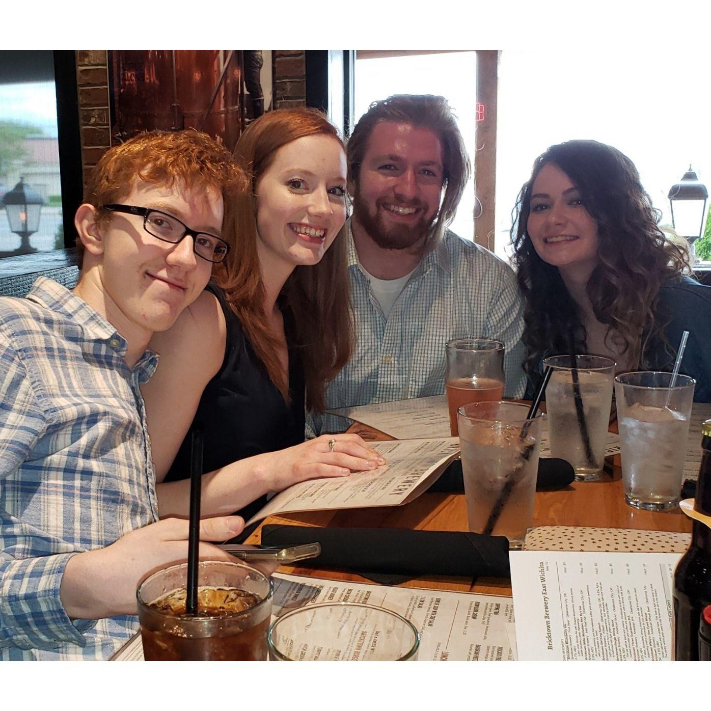 Amy's siblings, Gus and Sophie, celebrate Amy's graduation from Newman with William at Bricktown Brewery.
