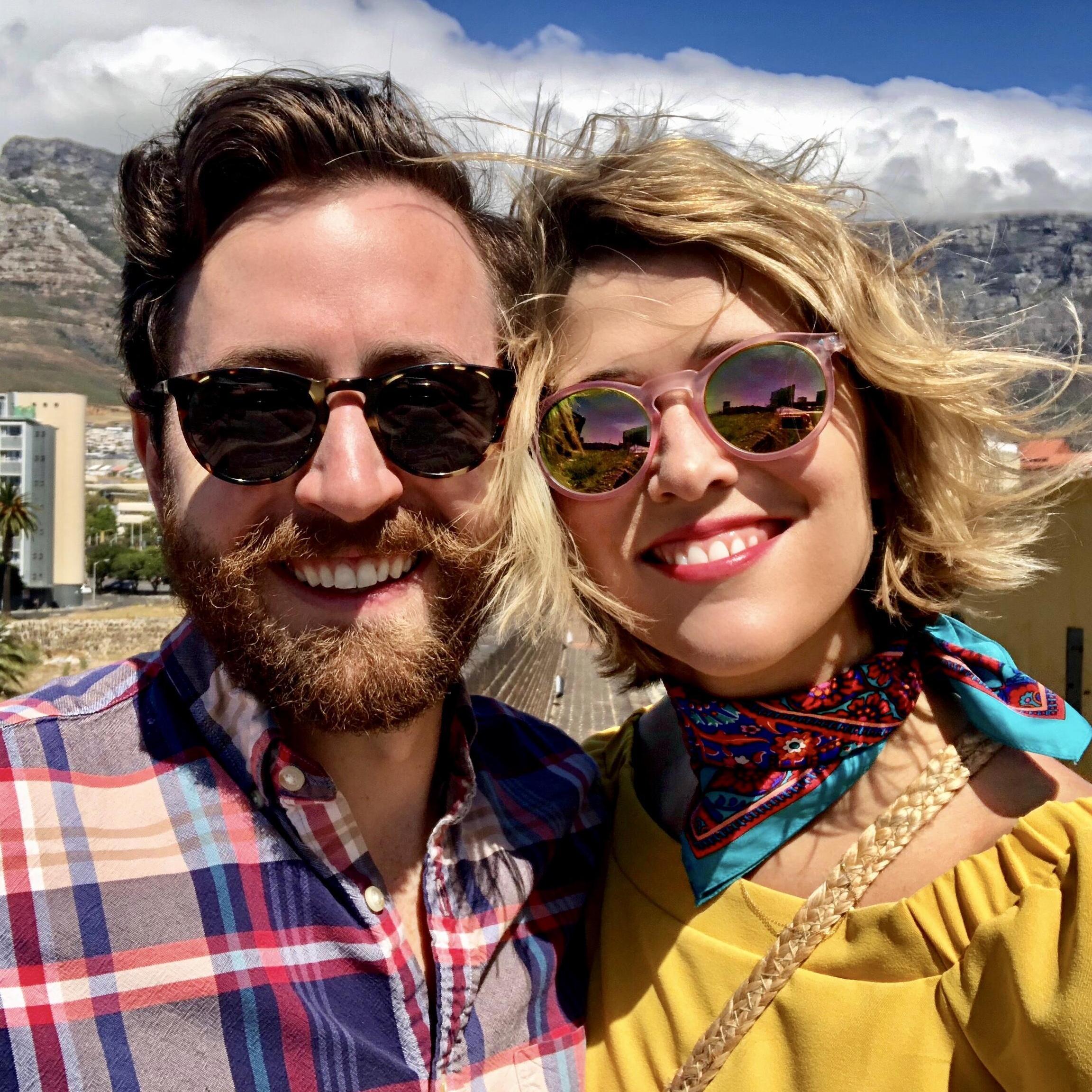 Selfie from our 2018 trip to Cape Town (with Table Mountain sitting pretty in the background)!