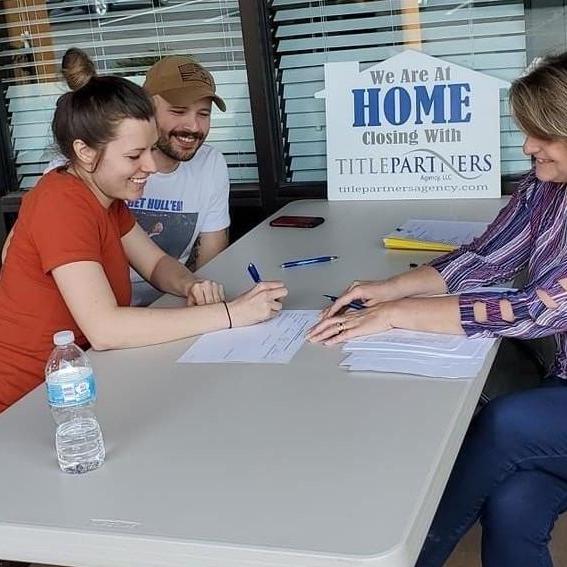 Cassie and I signing on our home together!