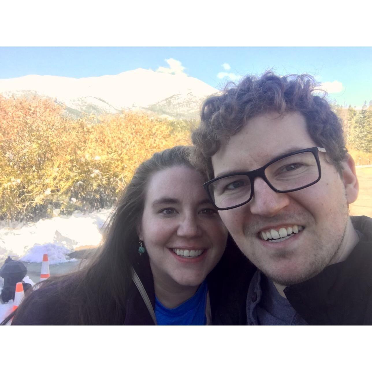 Taking a selfie in front of a snow-capped mountain.