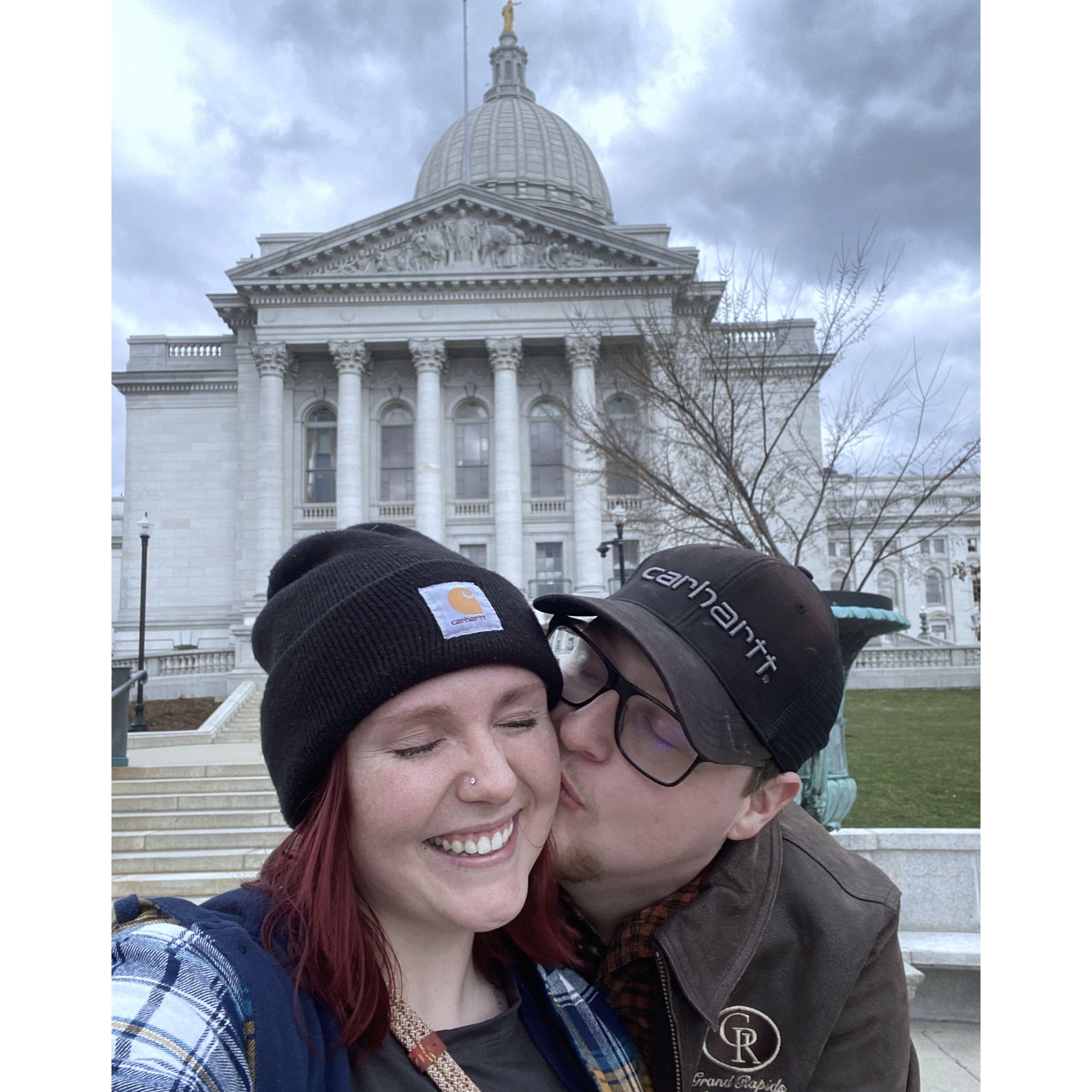 A little kiss outside of Madison's state capitol building.