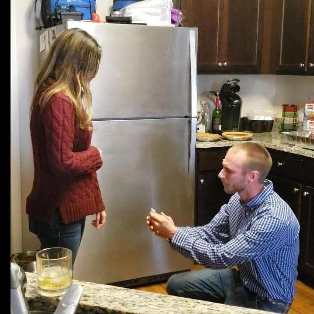 Chris getting down on one knee surrounded by family!