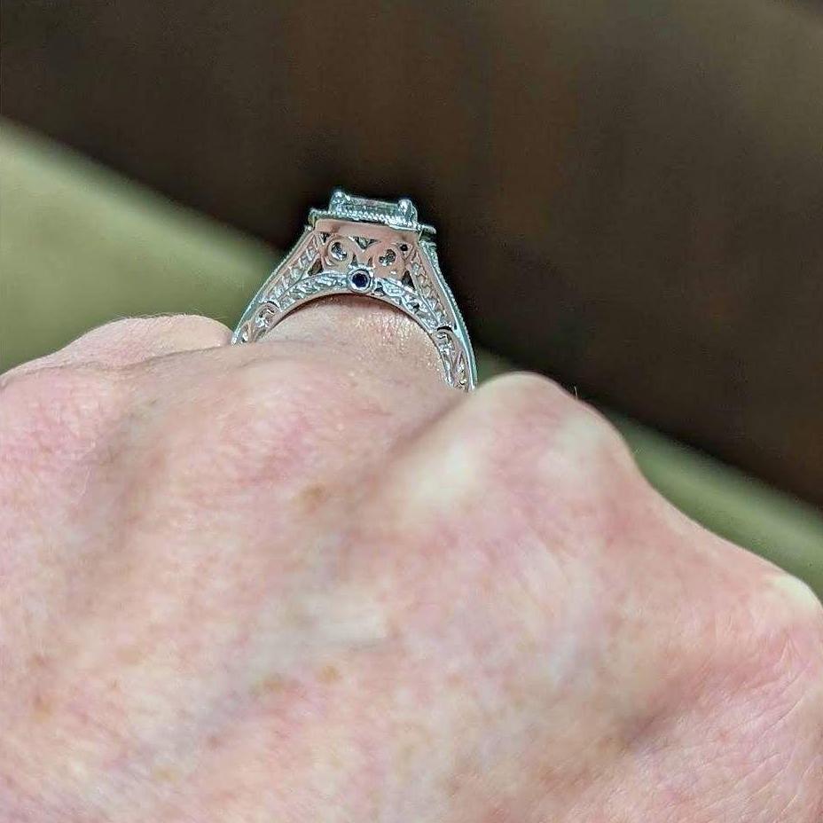 The sides have filigree engraving to honor Lorena's Celtic heritage and Sapphire chips for Mike's birthstone