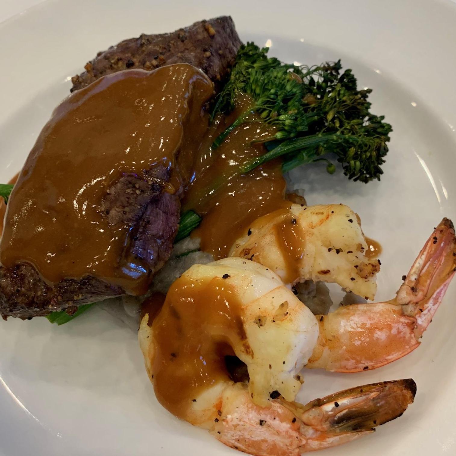 Grilled Prime Flat Iron Steak & Jumbo Shrimp
Purple Mashed Potatoes, Broccolini, Dark Gravy with Mustard