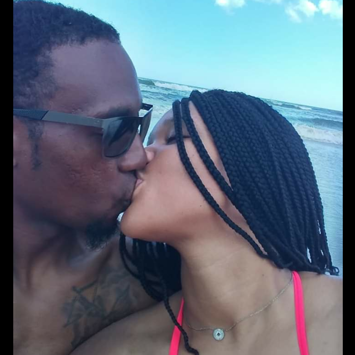 Day after engagement kissing on the beach.