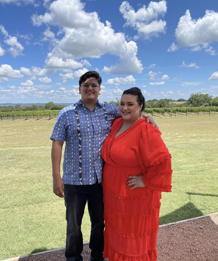 Photo of the couple in front of Narrow Path Vineyard.