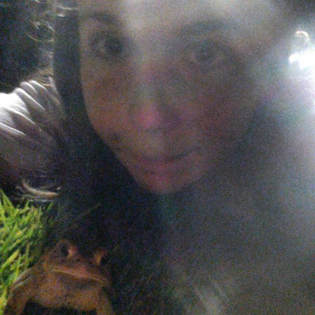 Emily with a toad at Memorial Park on a warm summer evening.