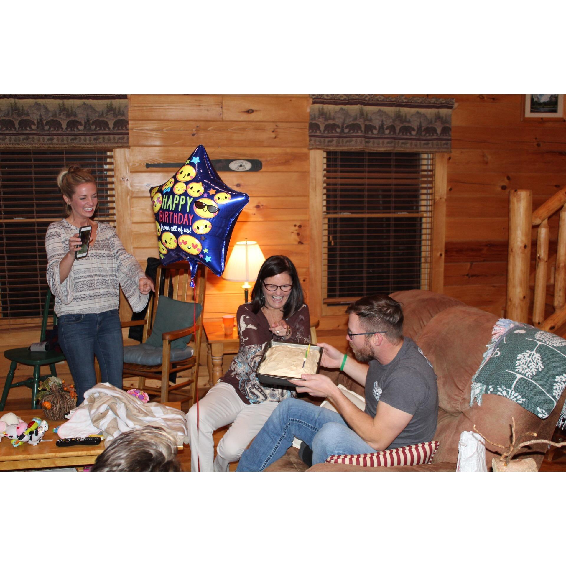 Facetiming Casey's mom to let her in on surprising Casey with a small birthday celebration with Elise's family. Elise's mom, Pam holding the homemade cake.