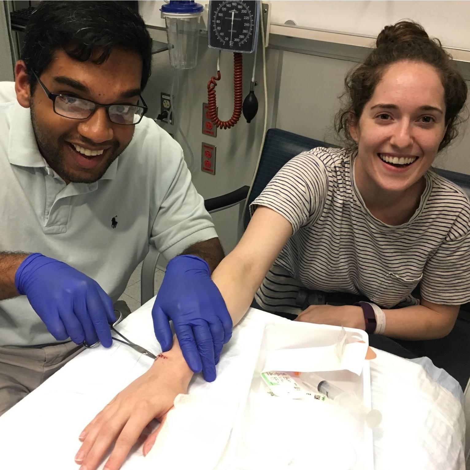 Completing stitches on his first live patient