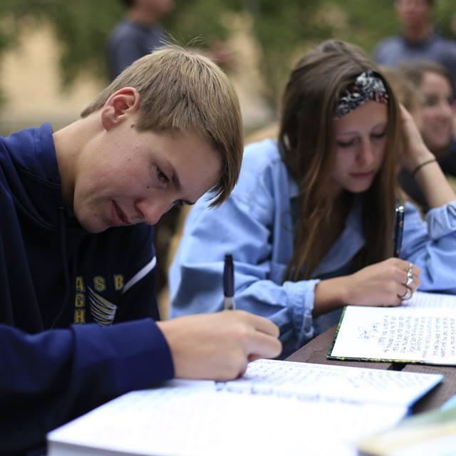 2014, signing each other senior year books.