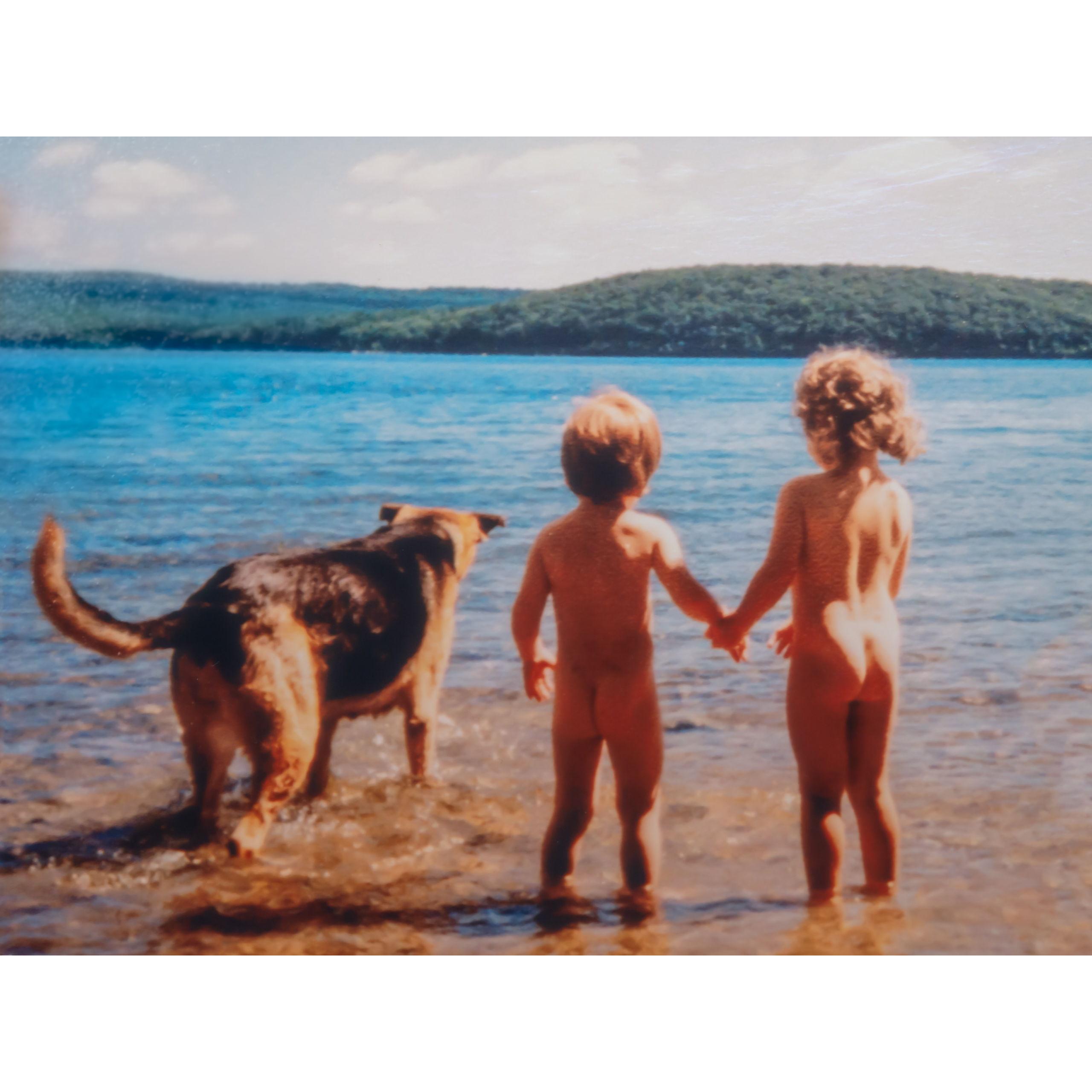 Holding hands as children, naked in a Massachusetts lake.