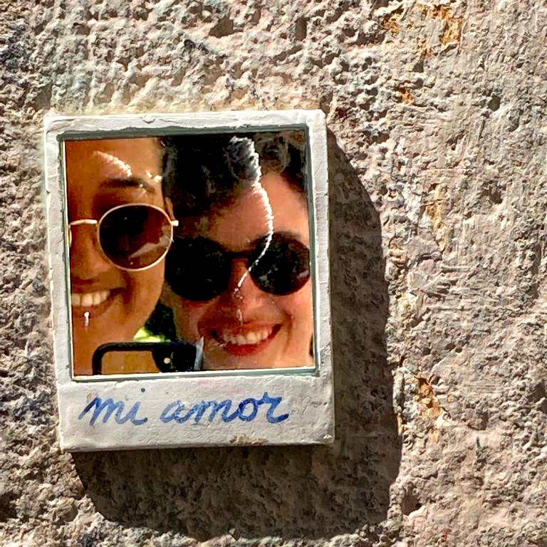 A tiny mirror tucked into the walls of Barcelona, glued right beside the piece "El Beso" a photo of a kiss made up of smaller images capturing all the different kinds of love people experience.
