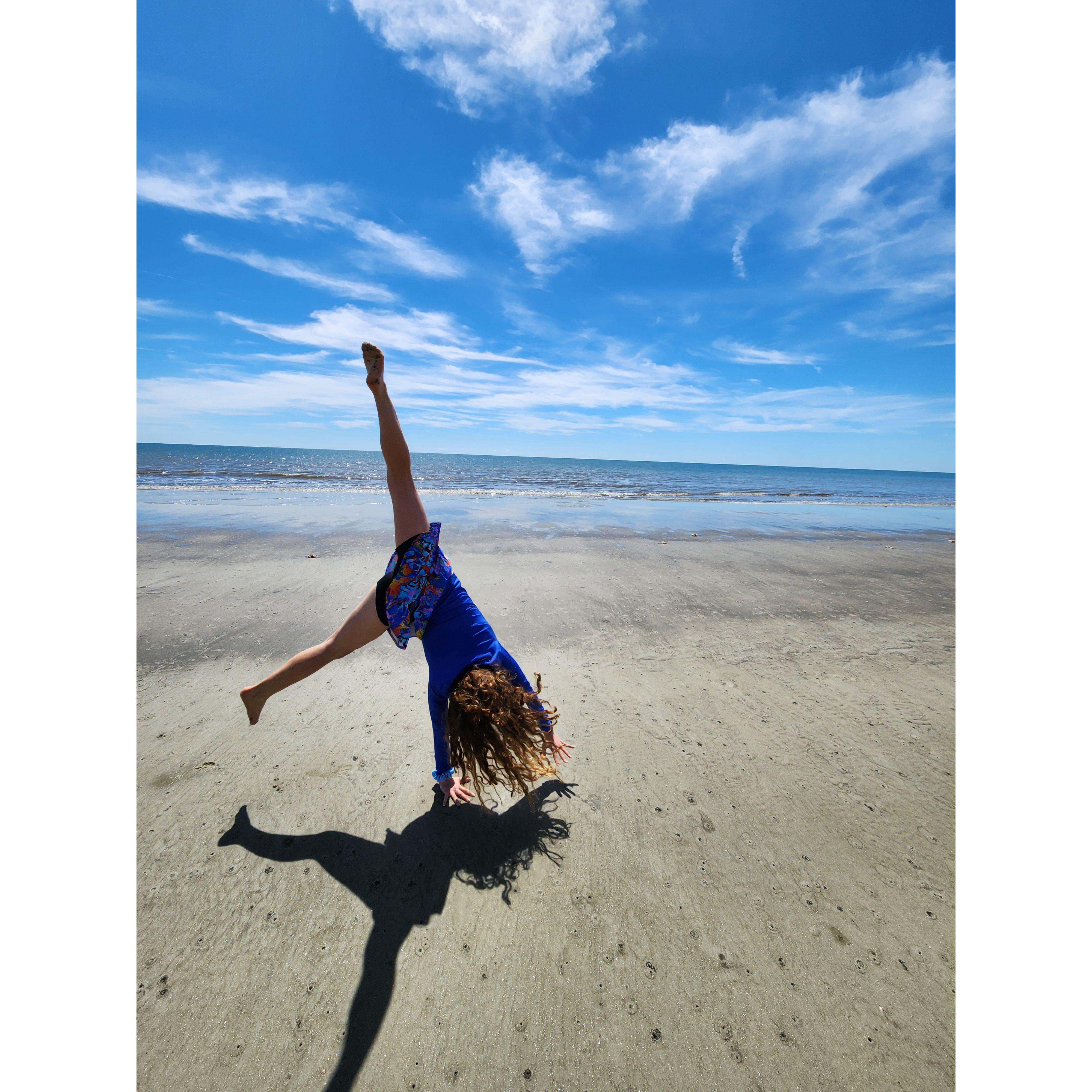 Annie doing a cartwheel on the beach at Hilton Head!