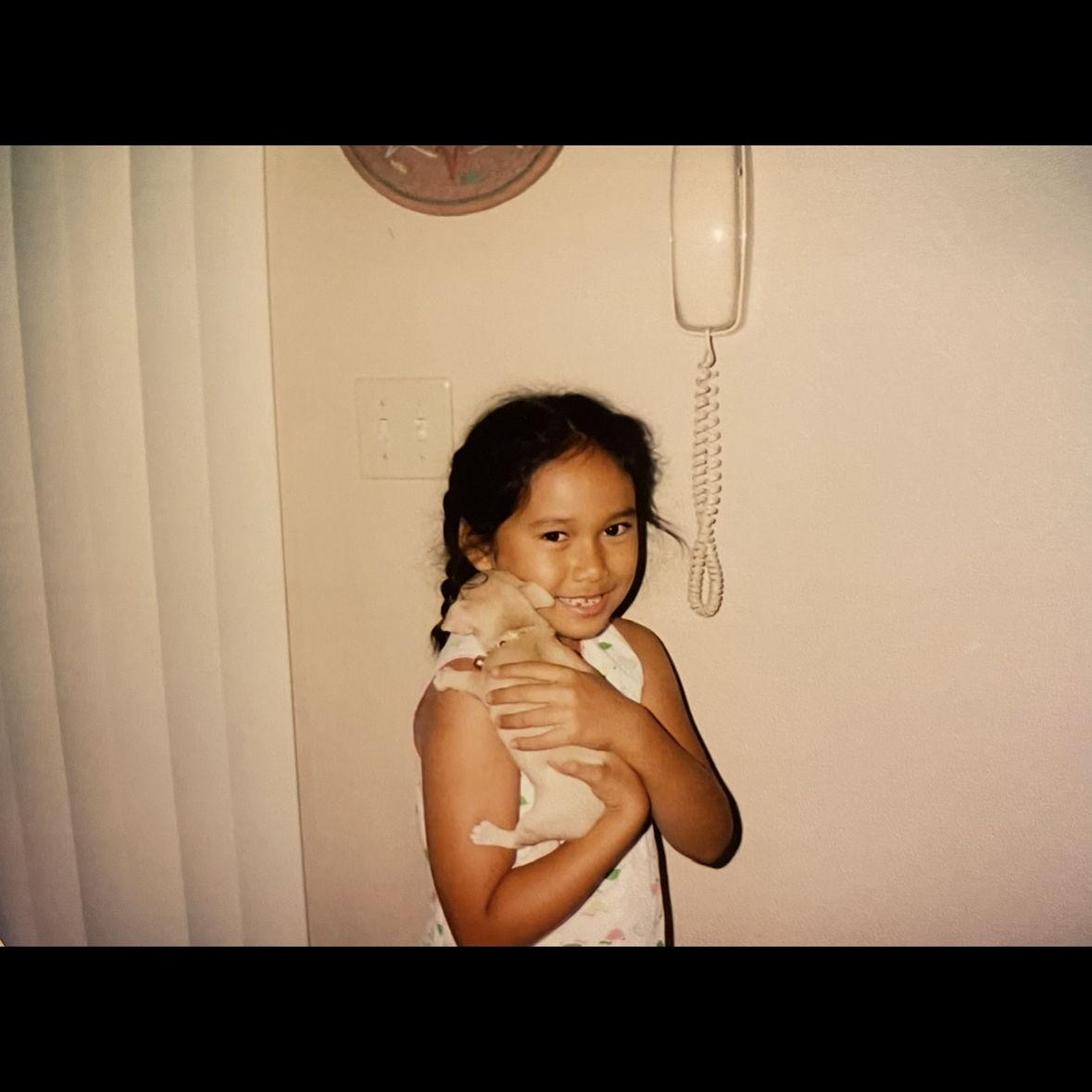 Mini Milla cradling her Nana’s chihuahua puppy, Chiquita.