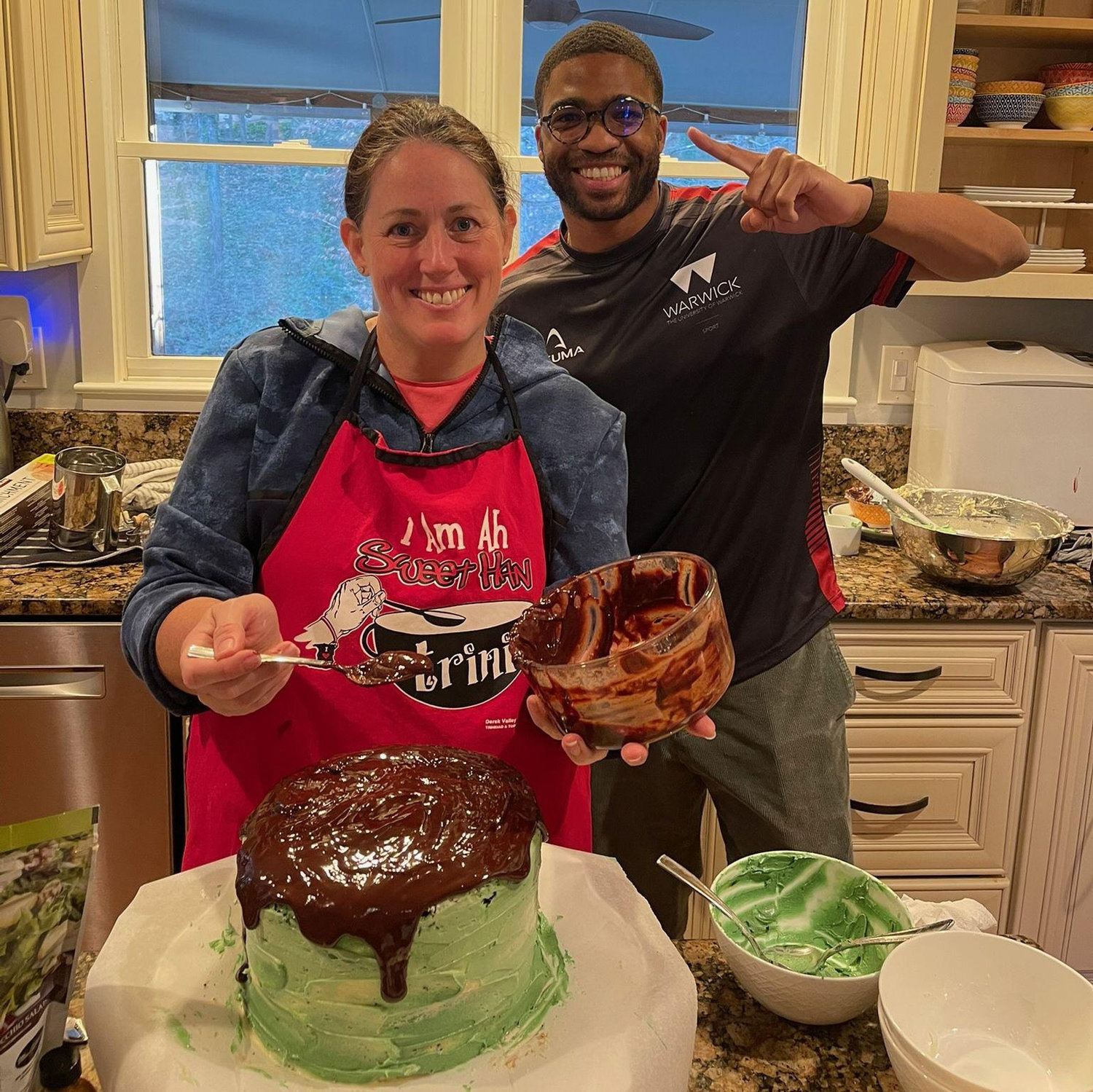 Sam providing support as Lynn makes a delicious cake