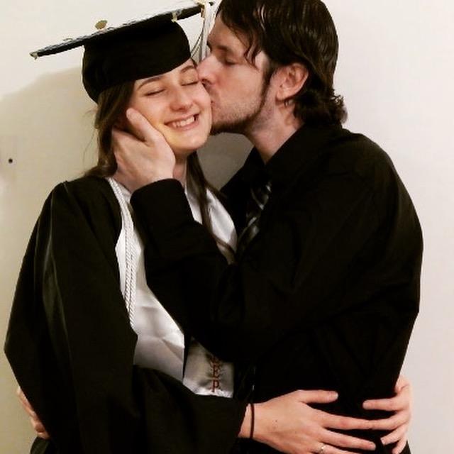 Kaleigh's not smiling because Chris is kissing her, she's smiling because she's finally done with her degree