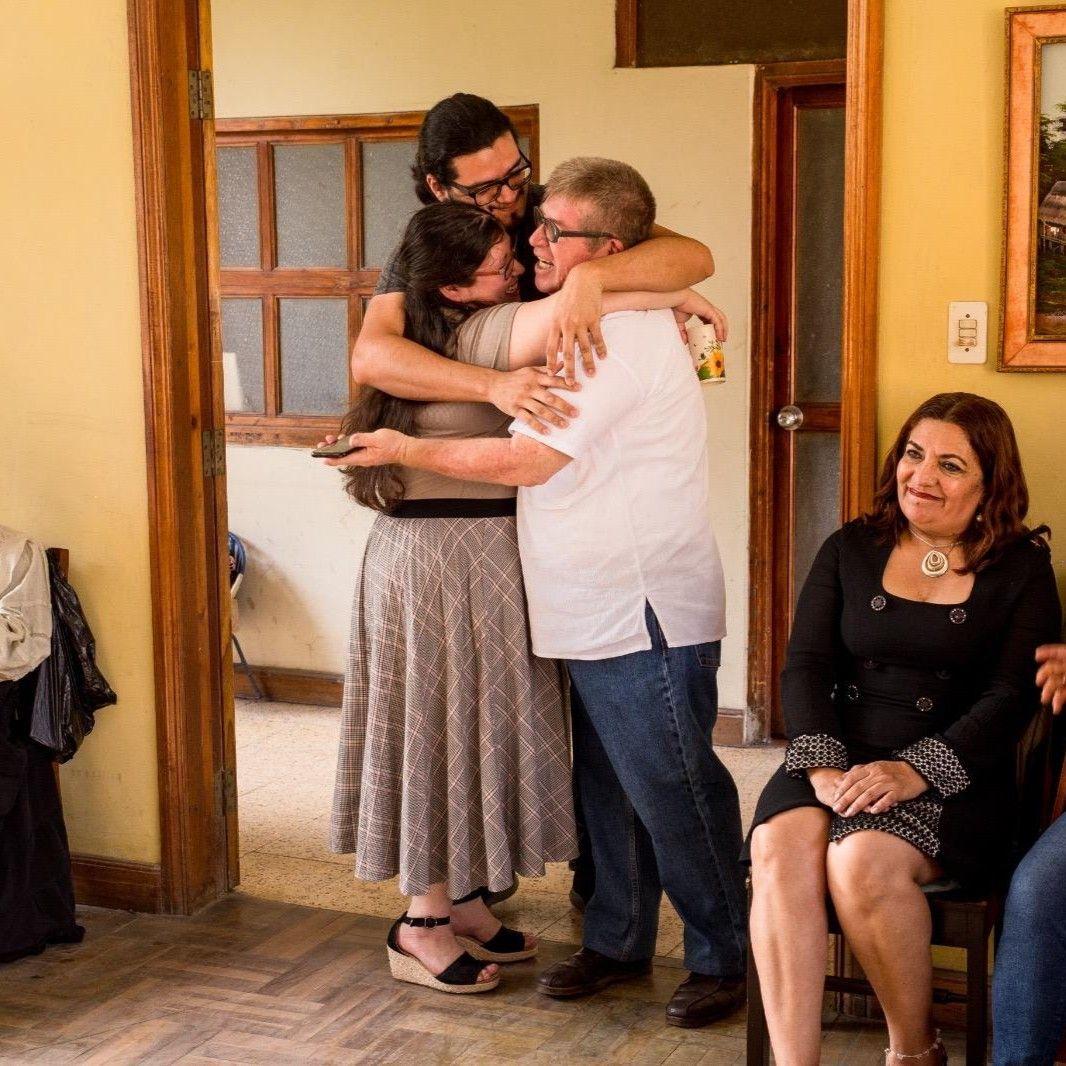 Family hug between Mary, Kenny, and Mary's dad, Marcial during their impromptu "engagement lunch." Moyobamba, Peru. August 2023.