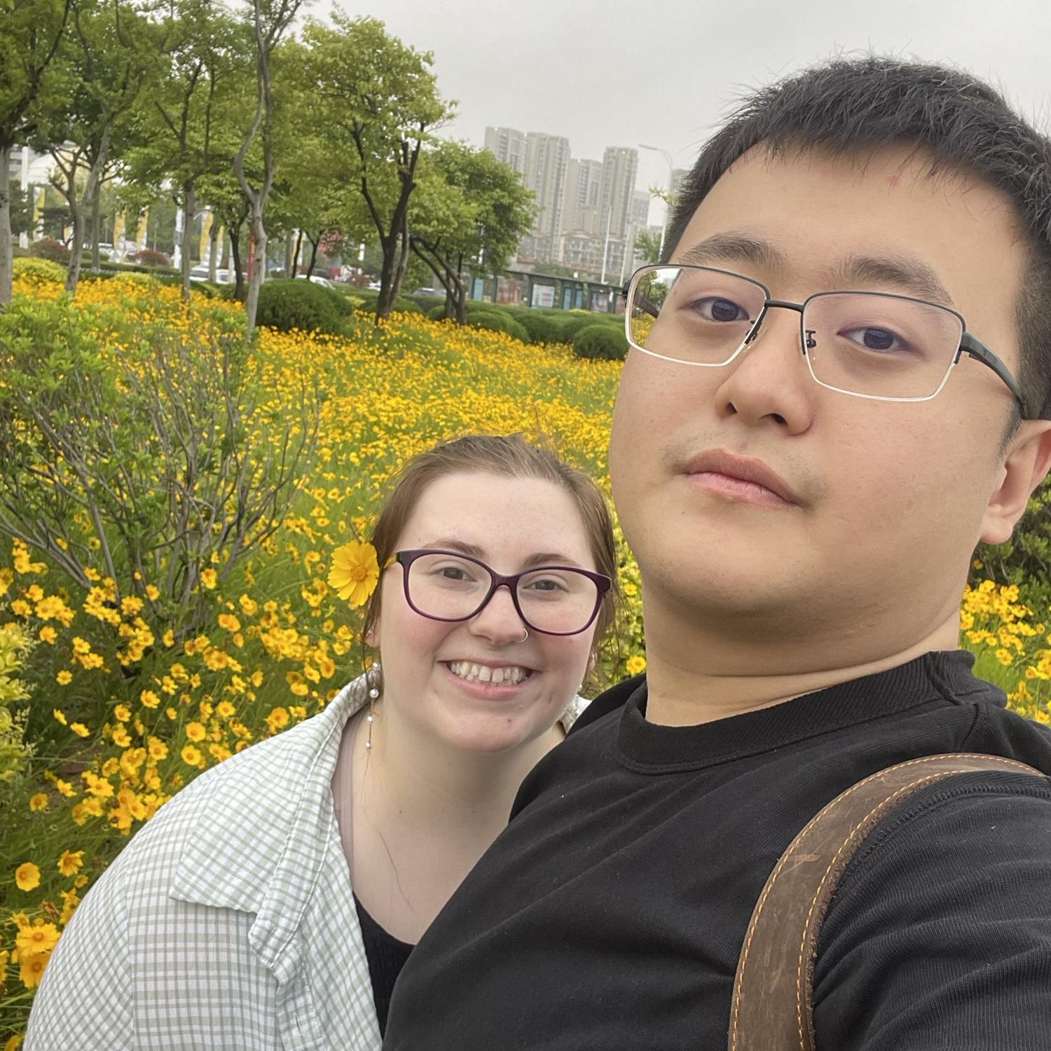 Stopping to enjoy the flowers near the beach in Qingdao, Shandong Province, China.