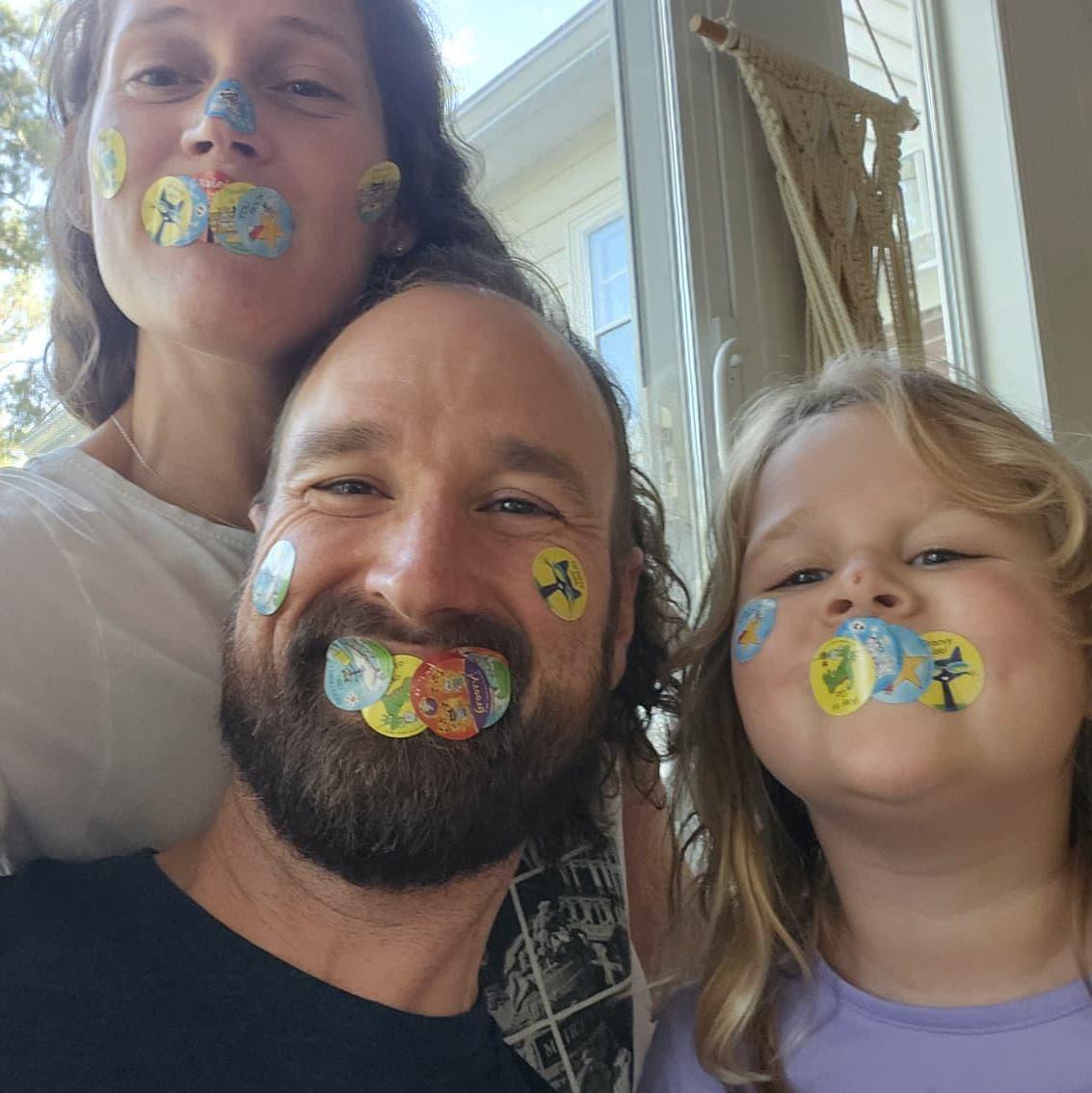 Ben, Kaity, and Eloise playing with stickers