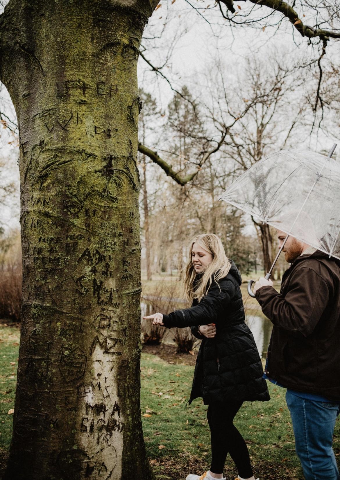 The couple carving their names in the special tree at Saint Mary’s College