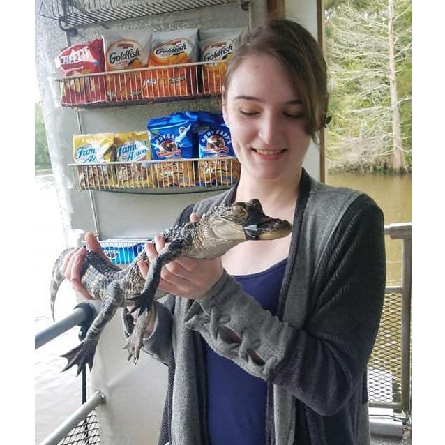 Since no real pictures exist of Isabel at graduation (as she hated everything and anything to do with such an event) here's her holding an alligator, because that's cool