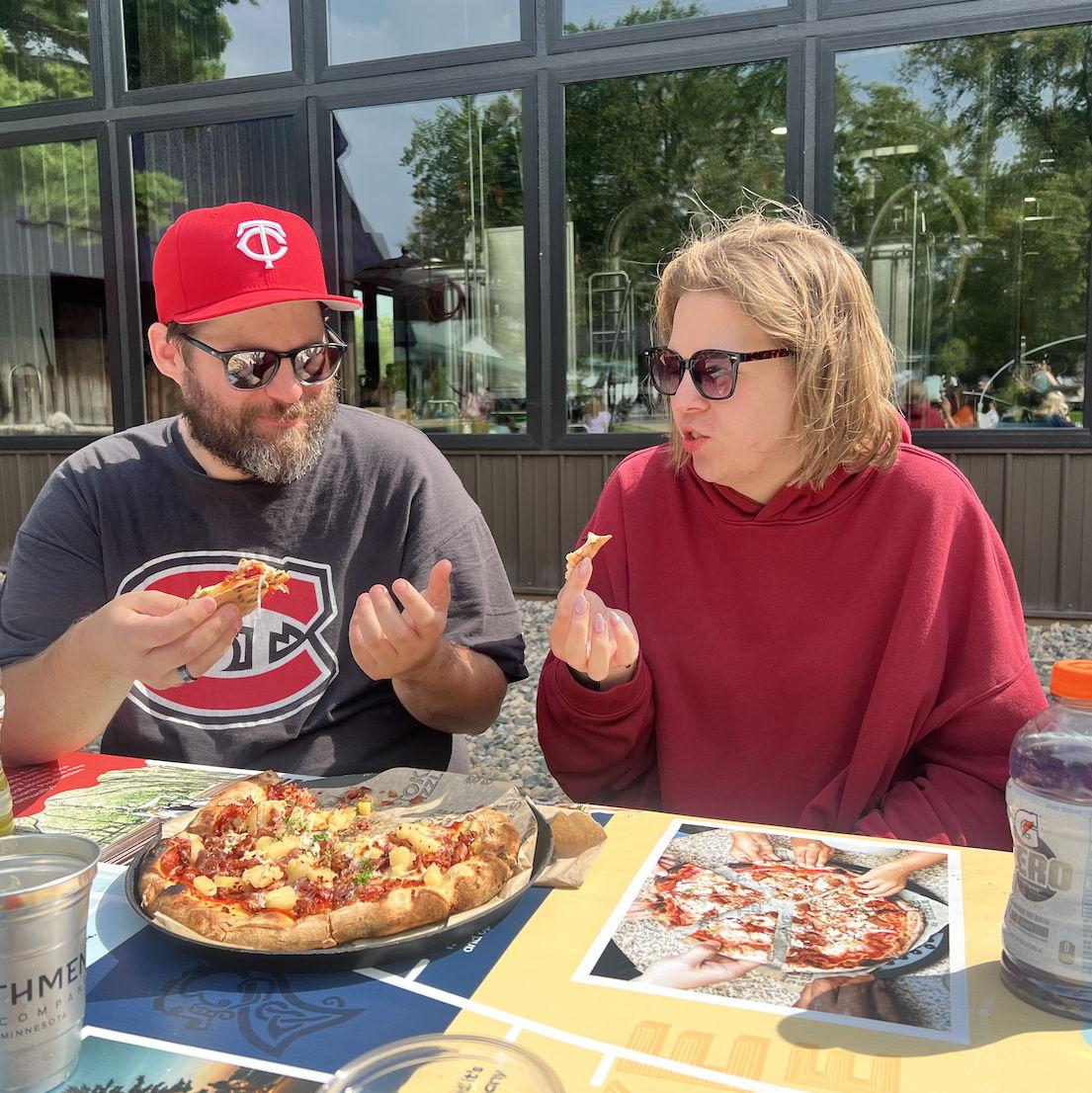 Enjoying pizza from 22 Northmen (we told you to check it out) — Kylie probably reminding Adam not to talk with his mouth full while doing exactly that herself.