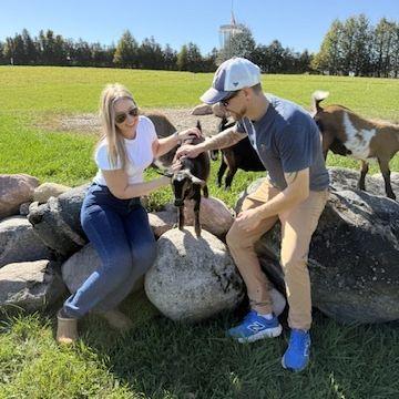 Innonciently playing with goats before Kyle popped the big question