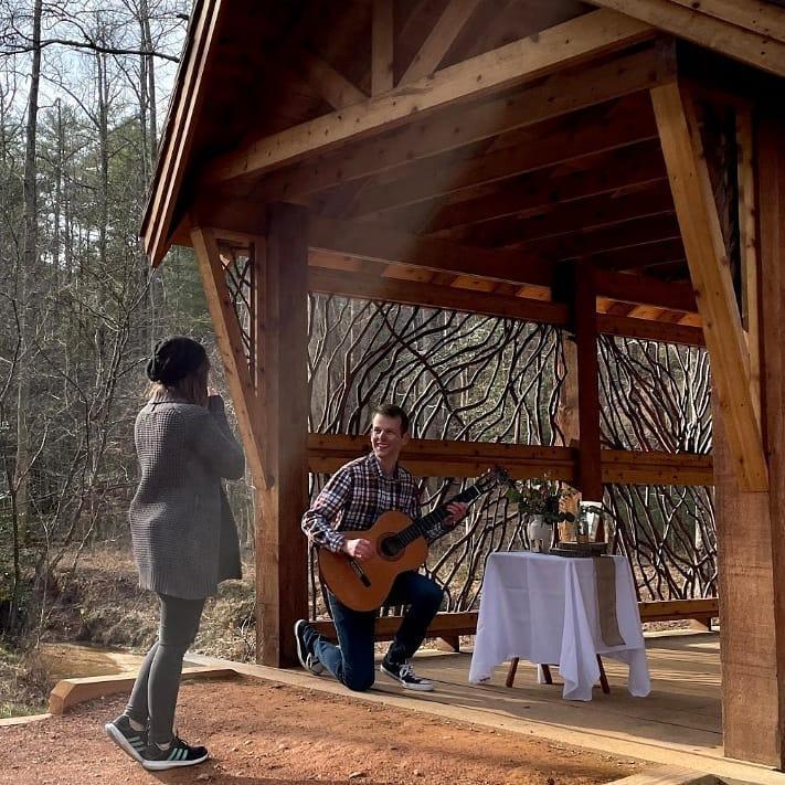 Laughing about the cold changing the tuning of his guitar.