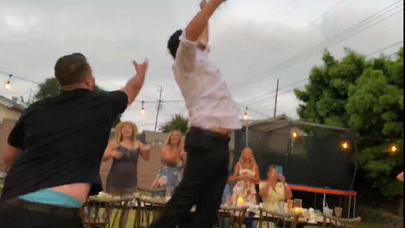 Scott catches the “garter” at their second wedding together!