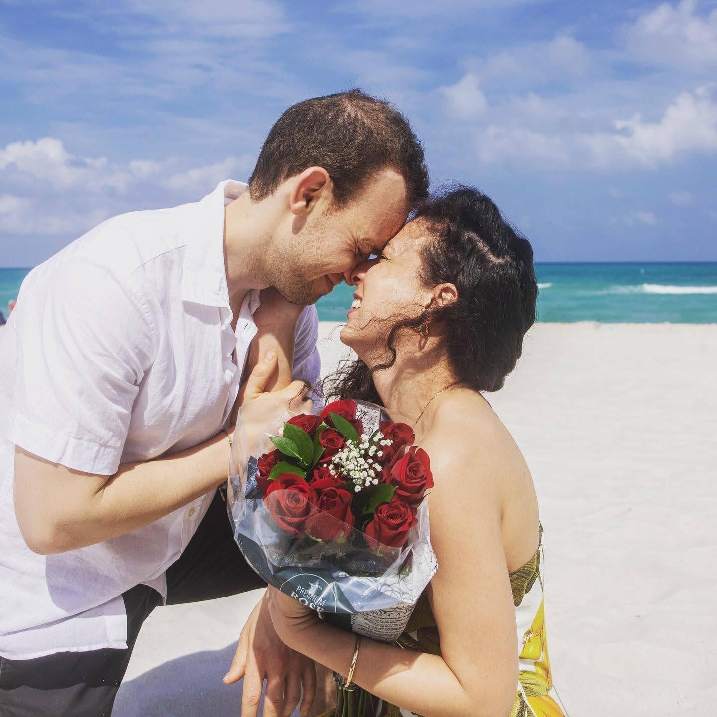 Little did Deanna know, a photographer had been following them down the beach carrying flowers and champaign!