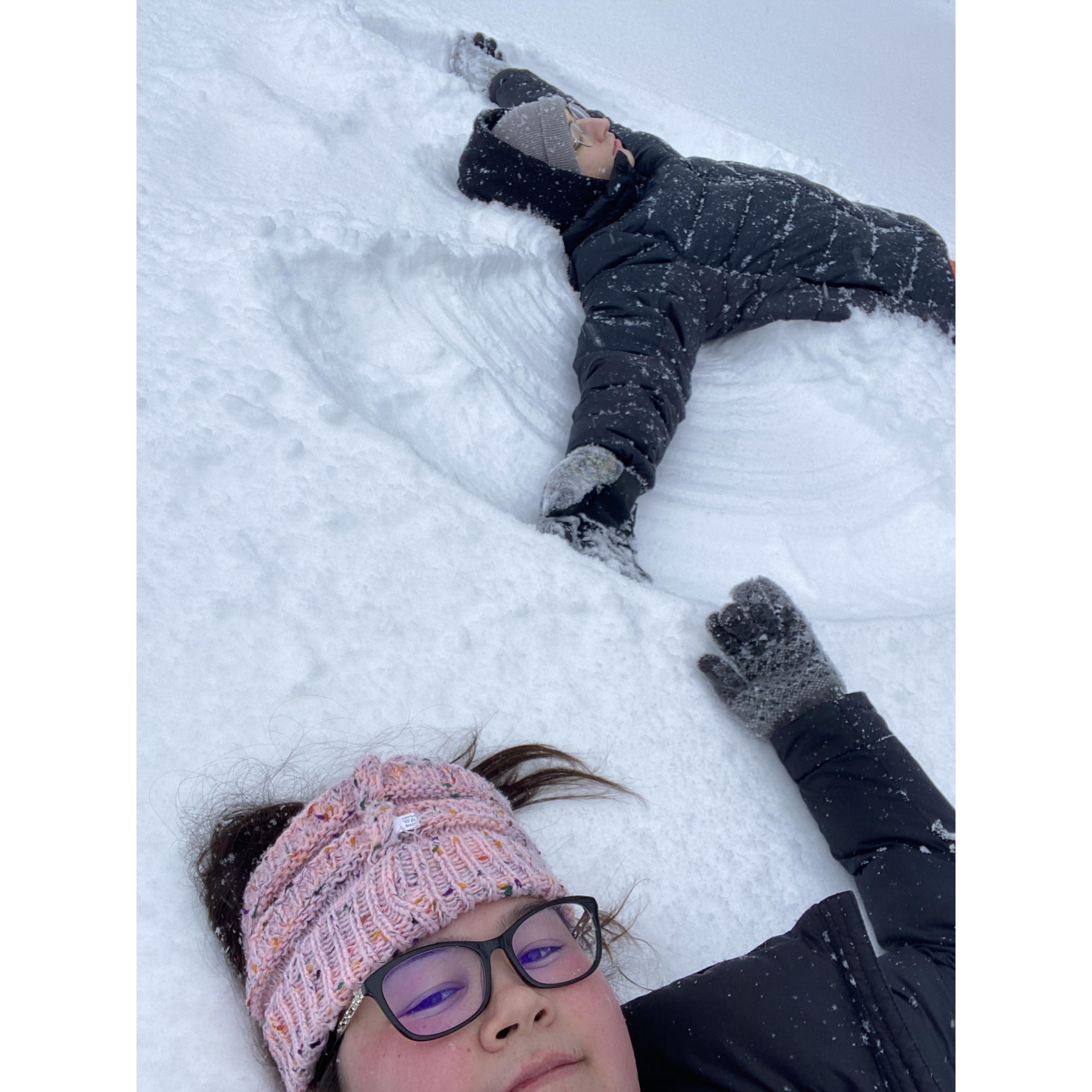 One of our favorite memories, laying in the snow while everyone drove by.