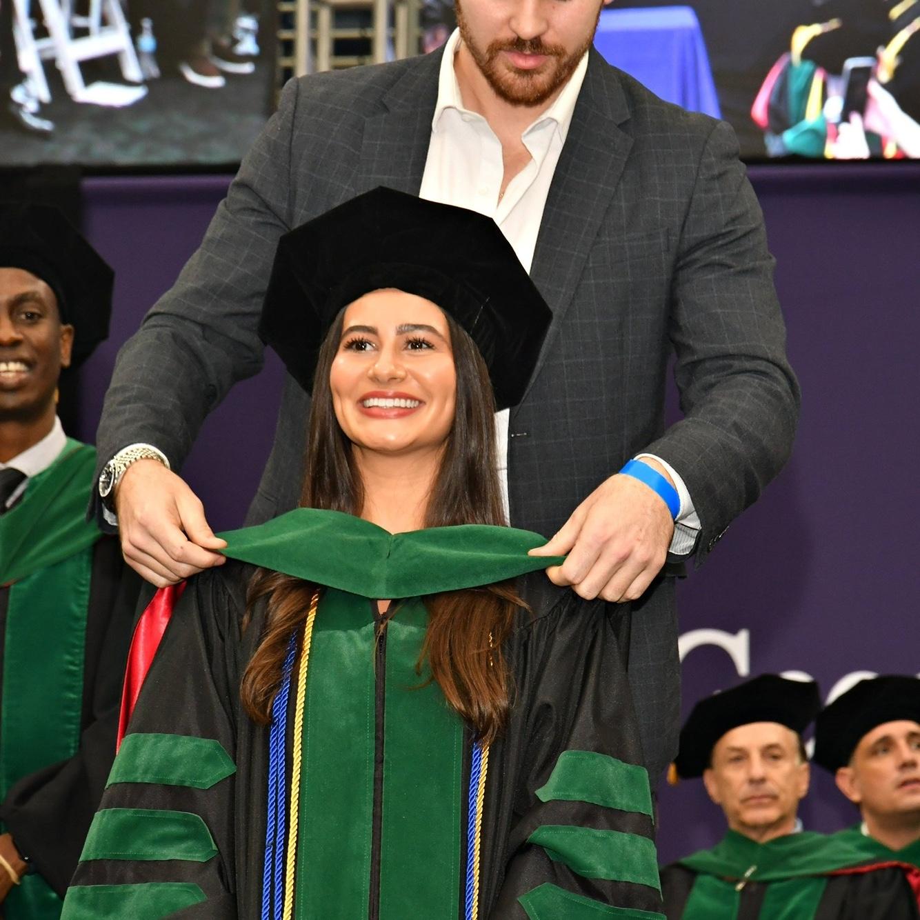 J "hooding" Mandy at her medical school graduation