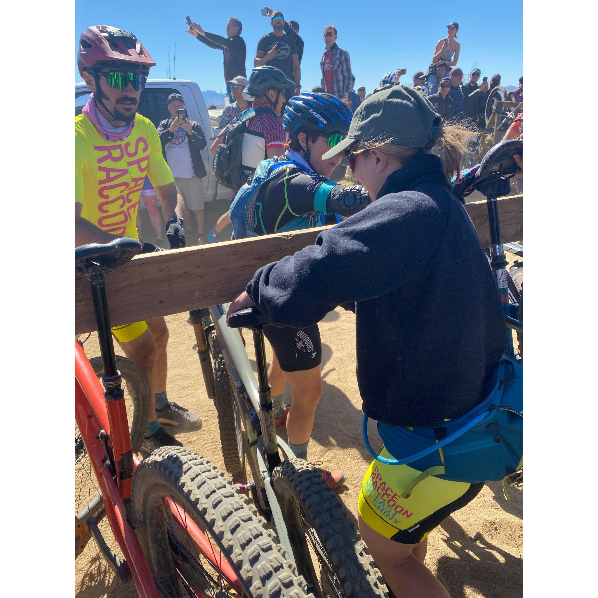 Kayla handing Mike his bike during the Lamas Start at 24HOP