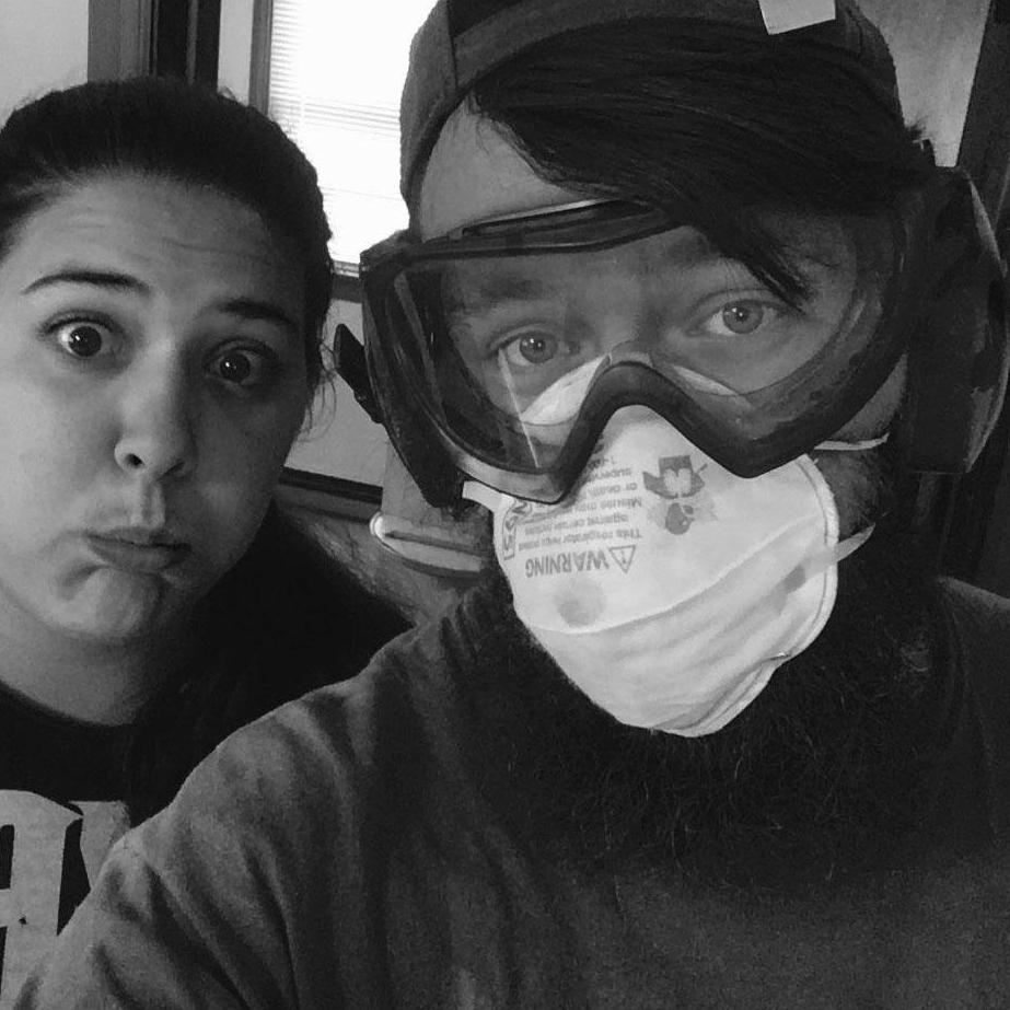Working hard sanding the wood-paneled room for primer and paint!